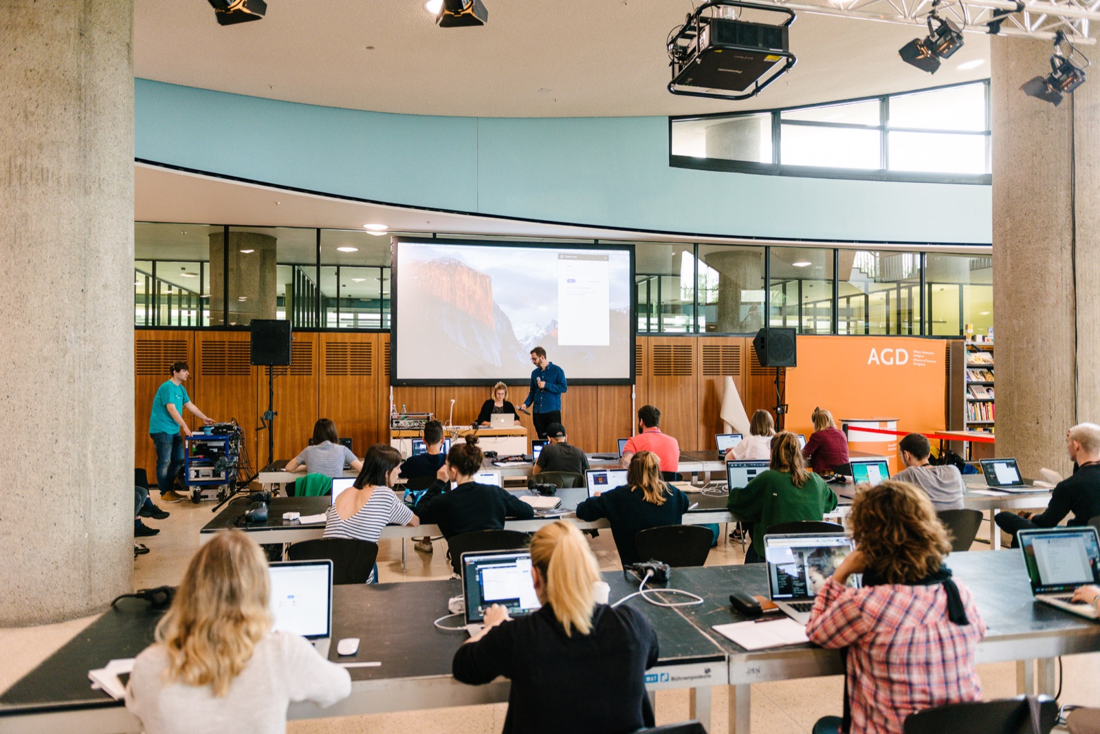 Workshop hall at Haus der Kulturen der Welt with participants at laptops facing a projection screen