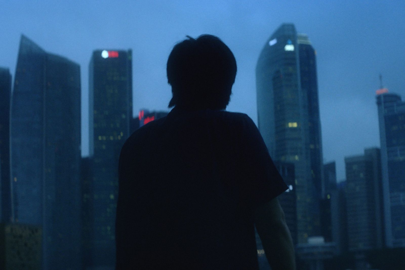 Gadget maker silhouetted against the Singapore skyline at dusk, still from the Indorse portrait film