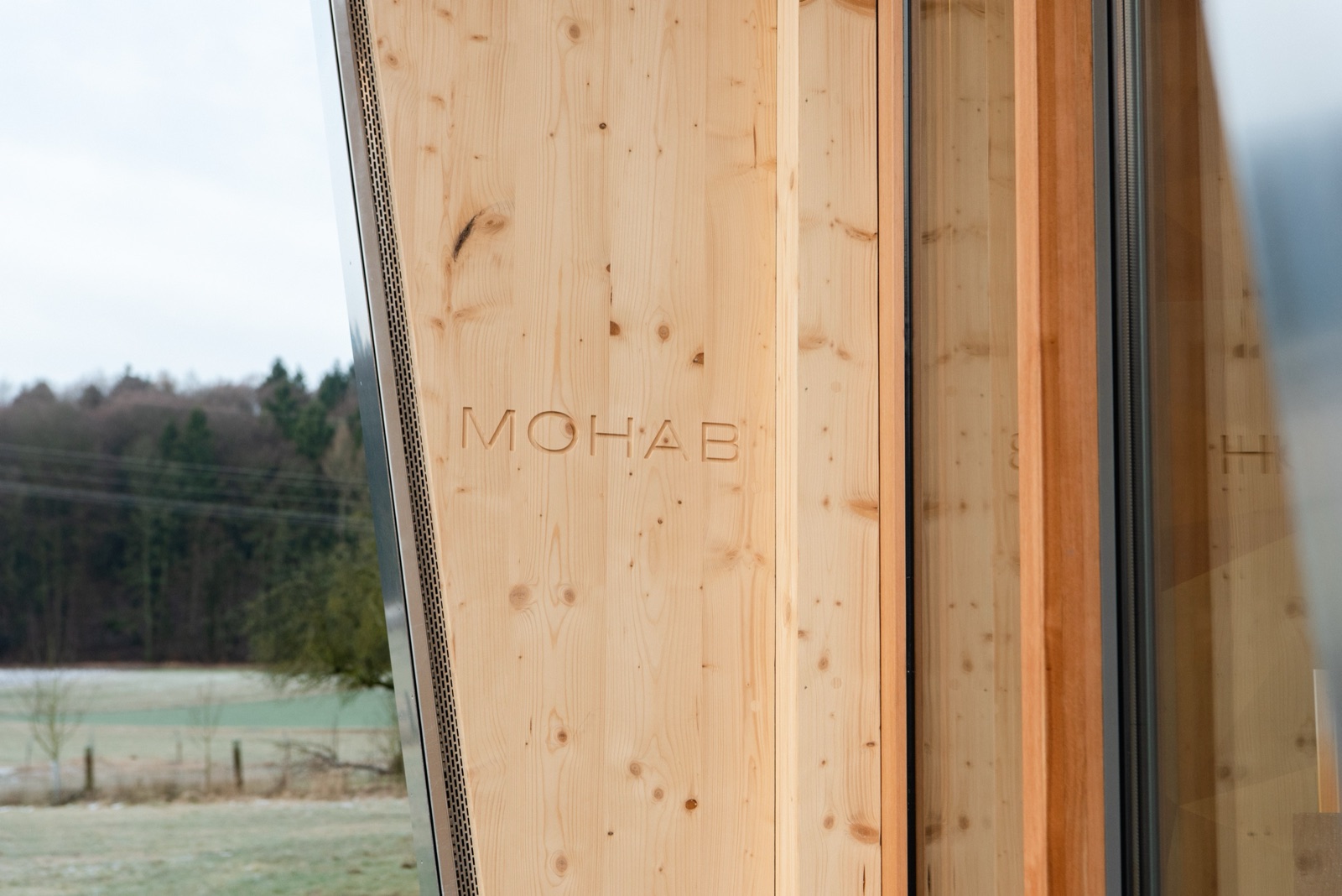 MOHAB logo engraved into a timber facade