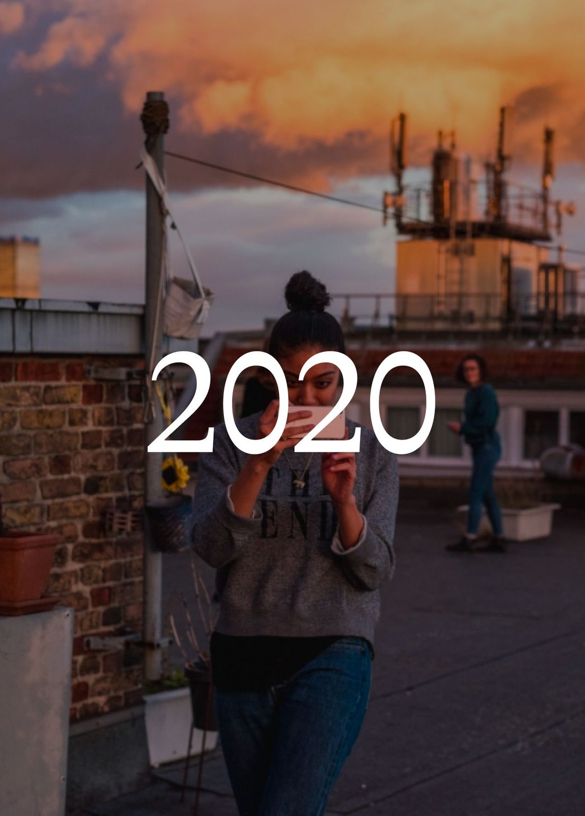 Person on a rooftop at sunset with antennas behind, with the year 2020 set over the image