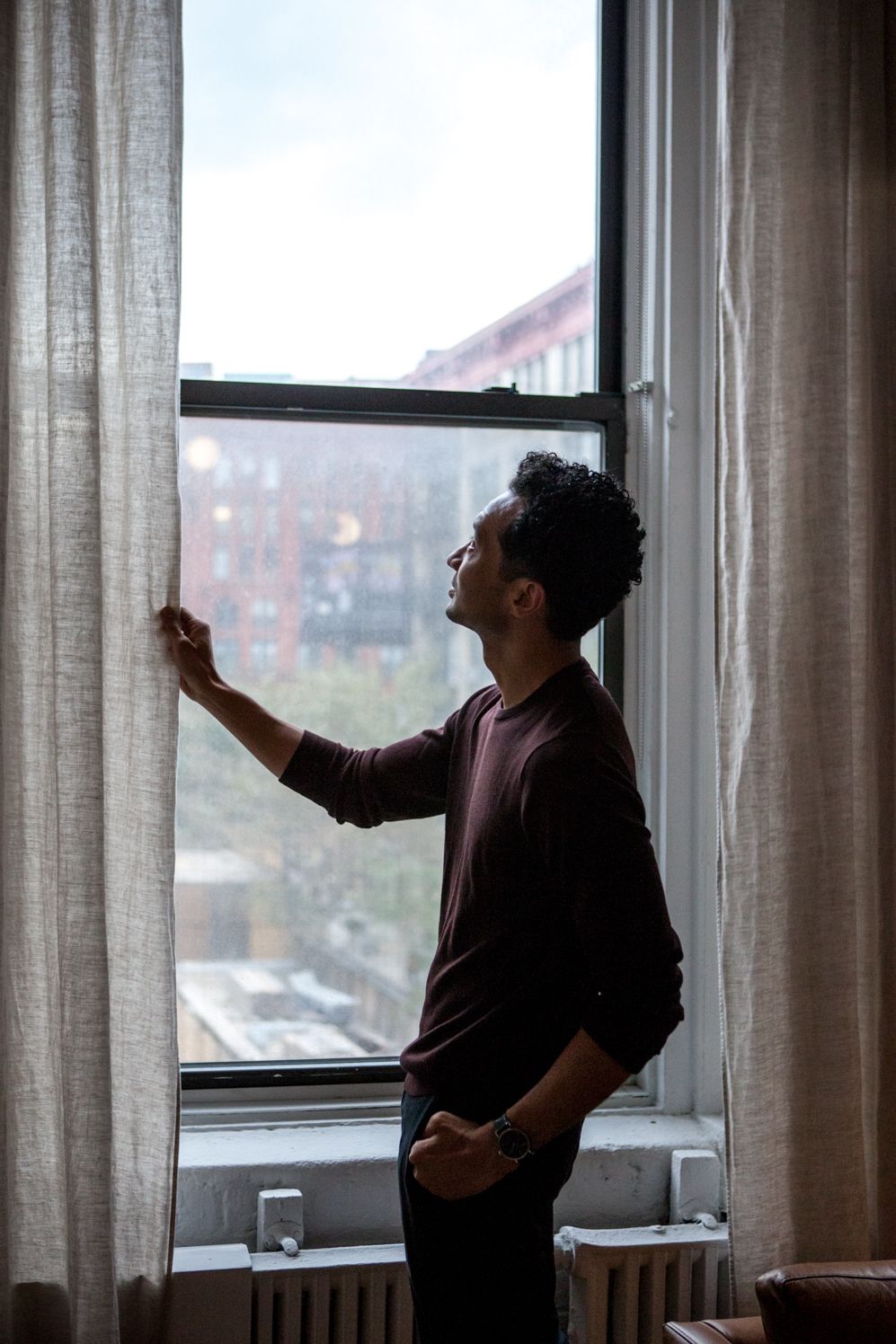 Founder by a tall window with long curtains in the NoHo showroom