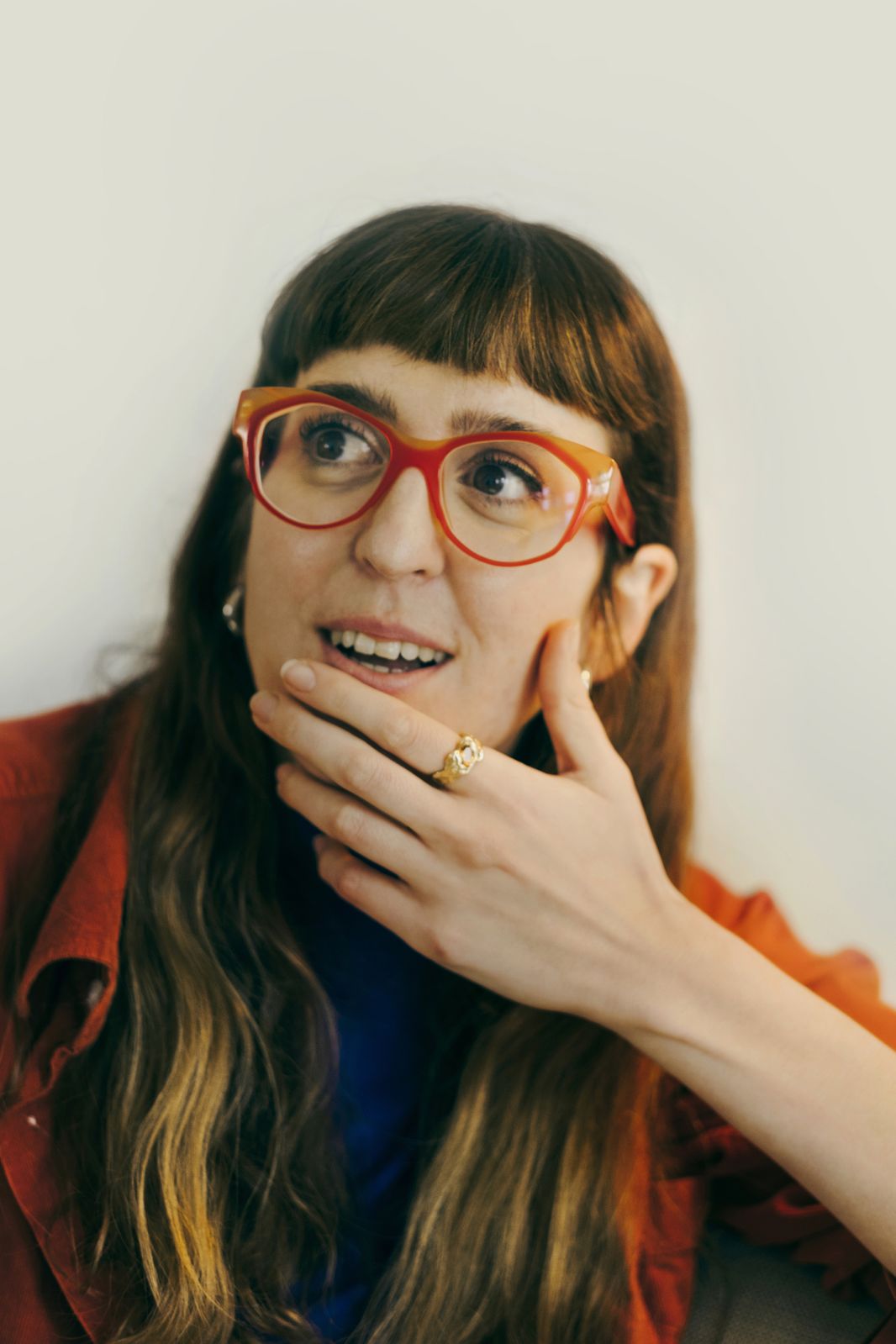 Portrait of a Journal Collective founder in red glasses