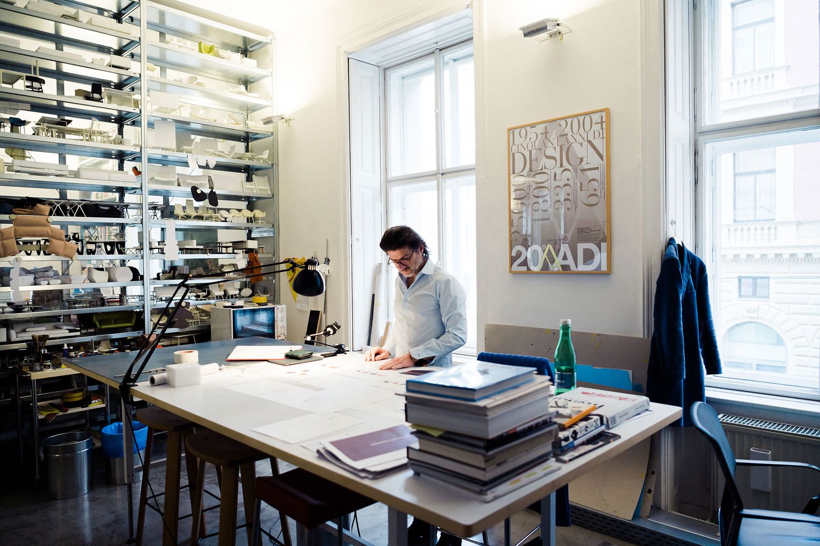 Harald Gründl working at a large desk in the EOOS studio, Vienna