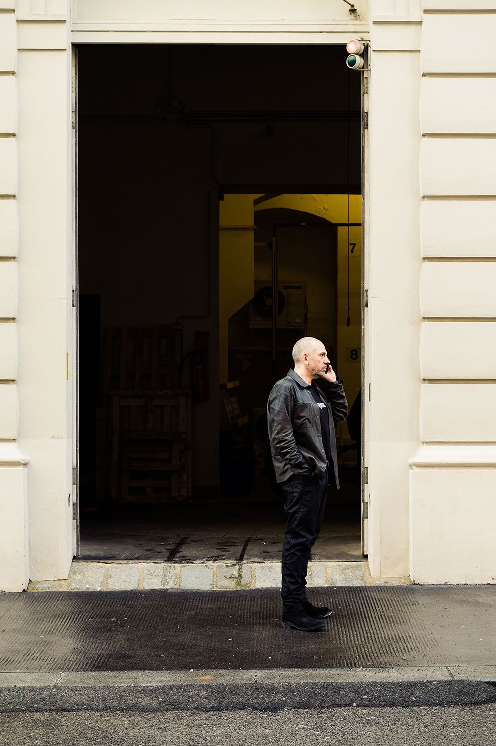 Harald Gründl on the phone in the doorway of the EOOS studio